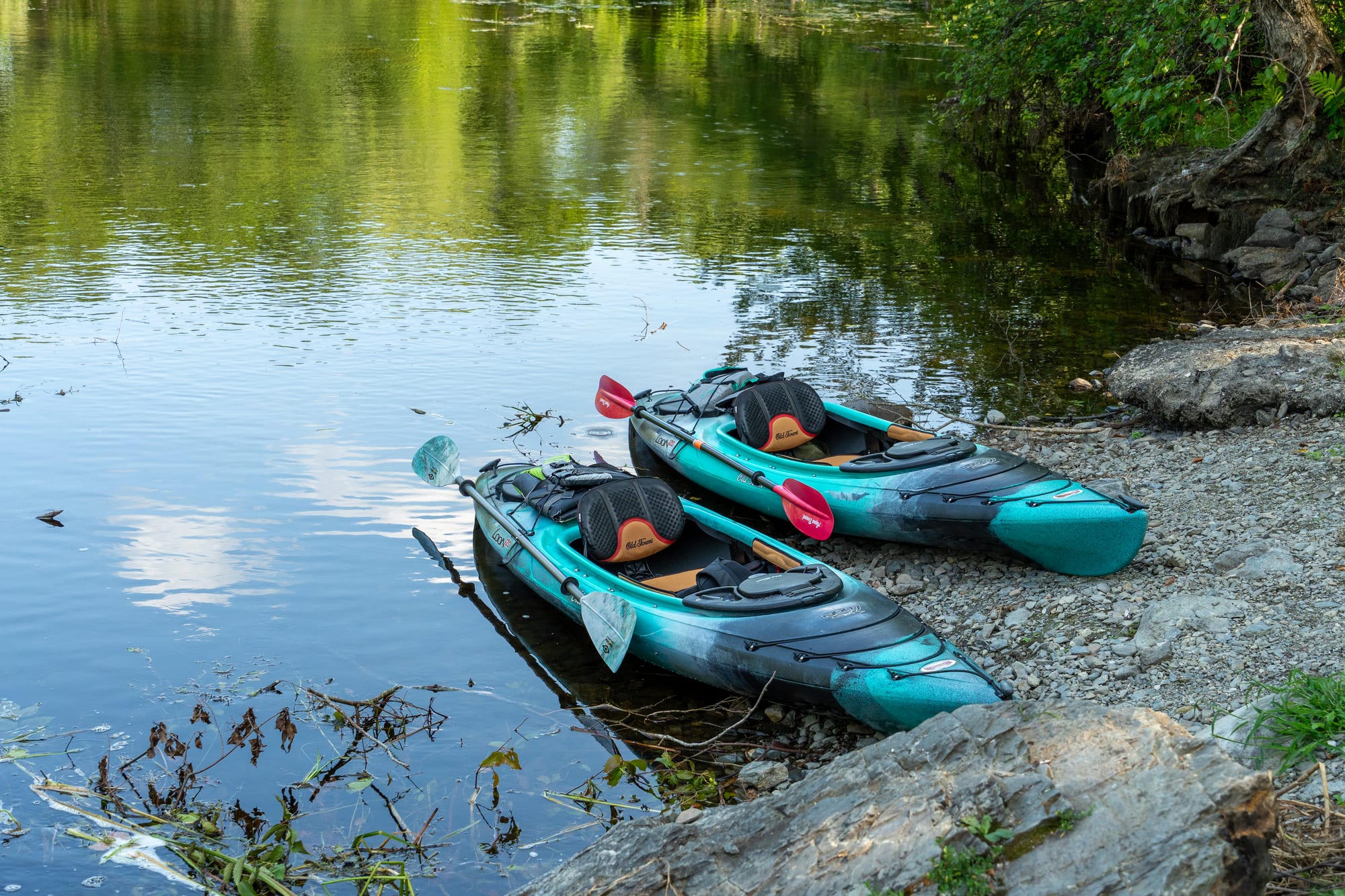 Two kayaks pulled up on shore at Hirundo Wildlife Refuge after a paddle.